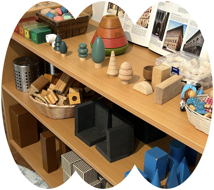 Shelves of Montessori materials and wooden blocks