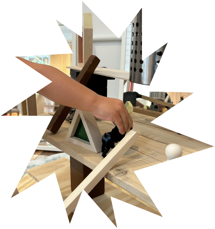 A child's hands building with wooden blocks